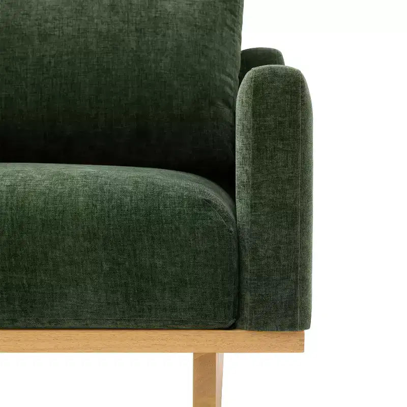 Poltrona moderna Niran in legno di gomma con rivestimento in bouclé e morbido cuscino